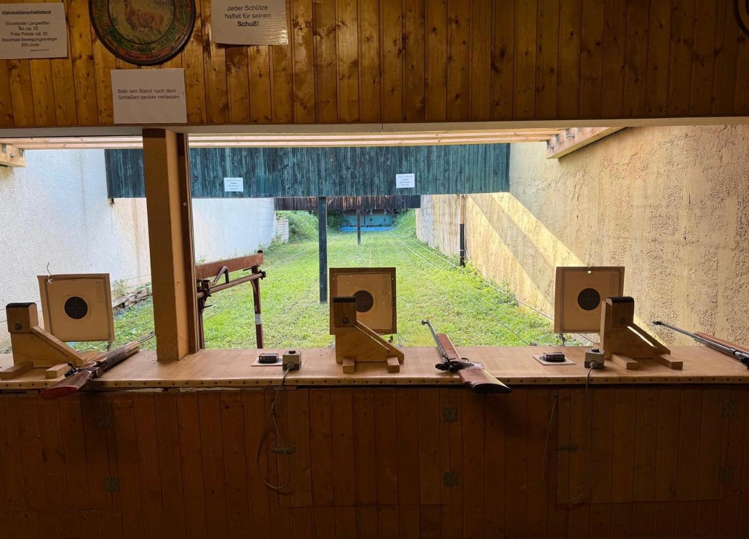 Schützenverein Bissingen/Enz e.V. – Ein Freiluft-Schießstand mit Holzunterständen, einer Rasenfläche davor und Papierscheiben, die auf mehreren Bahnen aufgestellt sind.